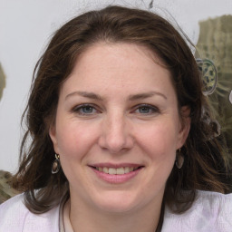 Joyful white adult female with medium  brown hair and grey eyes