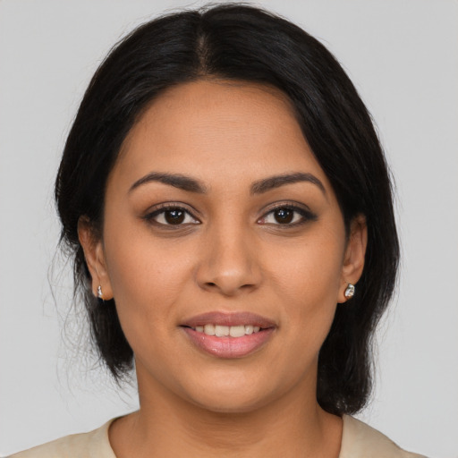 Joyful latino young-adult female with long  black hair and brown eyes