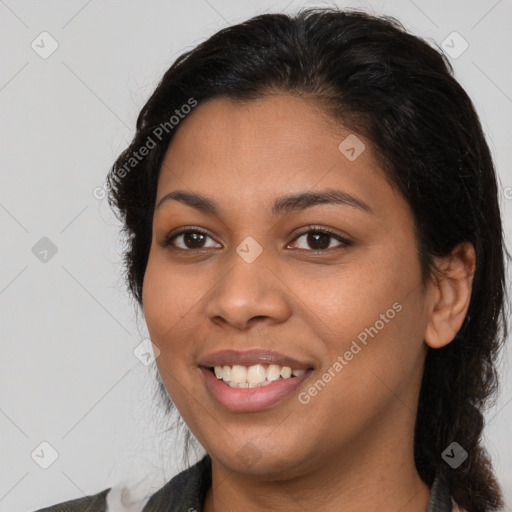 Joyful latino young-adult female with medium  brown hair and brown eyes