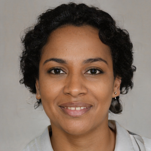 Joyful black young-adult female with medium  brown hair and brown eyes