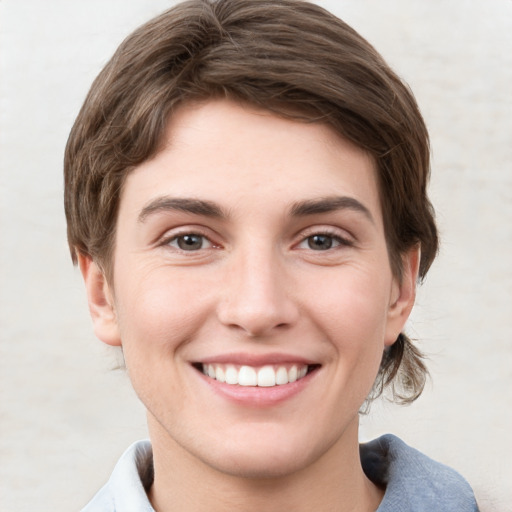 Joyful white young-adult female with short  brown hair and grey eyes