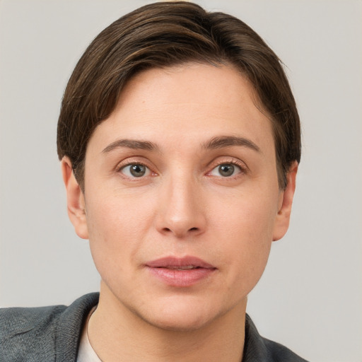 Joyful white young-adult female with short  brown hair and grey eyes