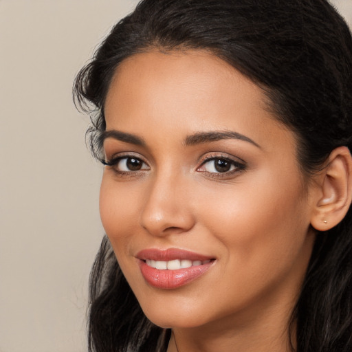 Joyful latino young-adult female with long  black hair and brown eyes