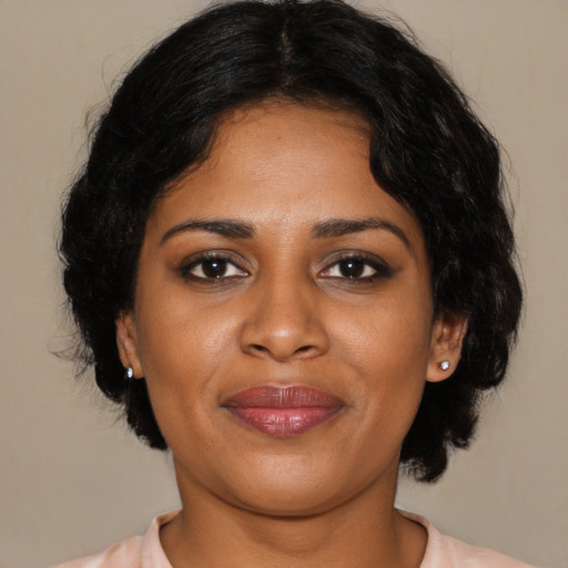 Joyful black young-adult female with medium  brown hair and brown eyes