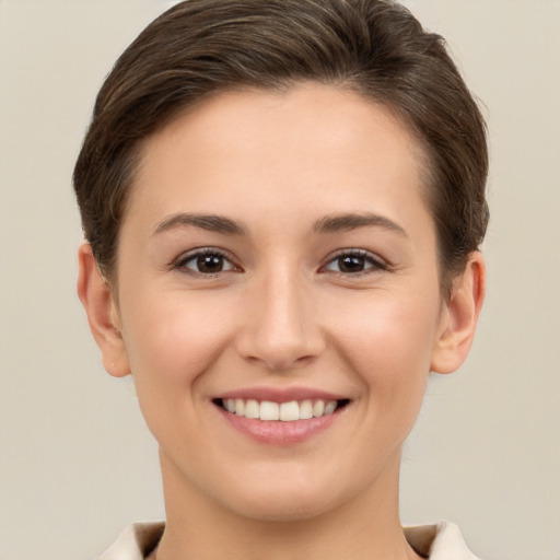 Joyful white young-adult female with short  brown hair and brown eyes