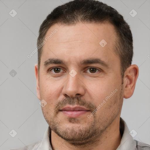 Joyful white adult male with short  brown hair and brown eyes