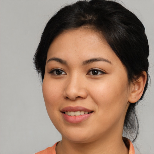 Joyful asian young-adult female with medium  brown hair and brown eyes