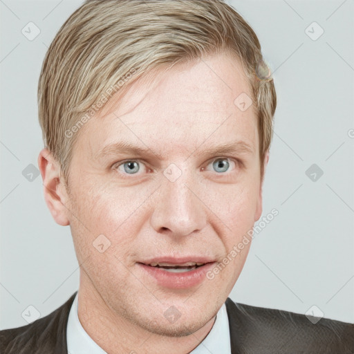 Joyful white adult male with short  brown hair and blue eyes