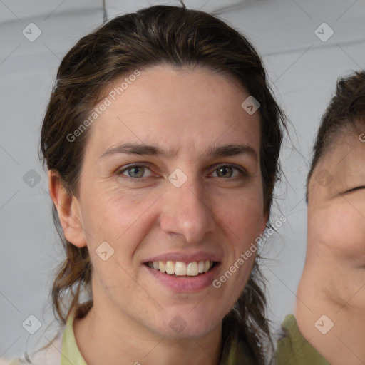 Joyful white adult female with medium  brown hair and brown eyes