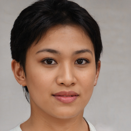 Joyful latino young-adult female with short  brown hair and brown eyes