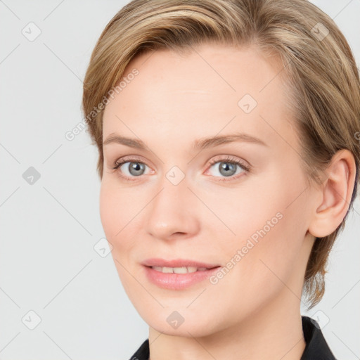 Joyful white young-adult female with long  brown hair and blue eyes