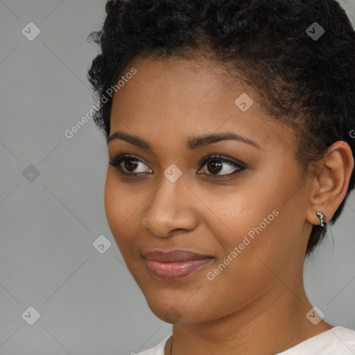 Joyful black young-adult female with short  black hair and brown eyes