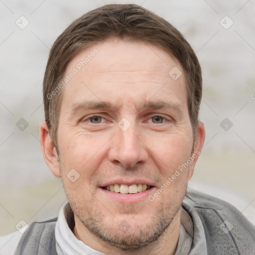 Joyful white adult male with short  brown hair and grey eyes