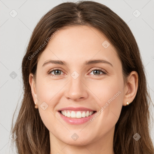 Joyful white young-adult female with long  brown hair and green eyes