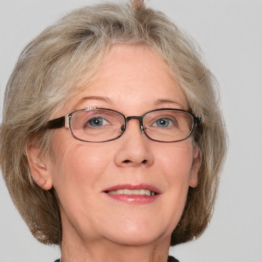 Joyful white middle-aged female with medium  brown hair and blue eyes