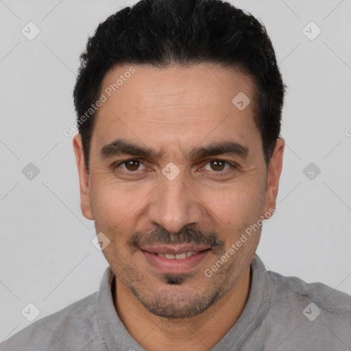 Joyful white adult male with short  black hair and brown eyes