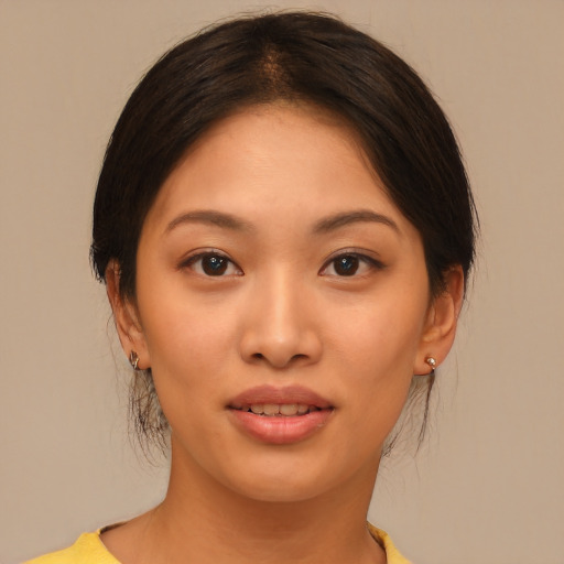 Joyful asian young-adult female with medium  brown hair and brown eyes