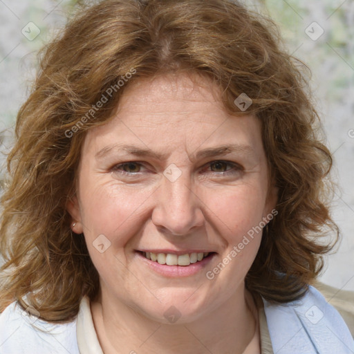 Joyful white adult female with medium  brown hair and blue eyes