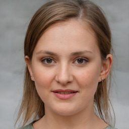 Joyful white young-adult female with medium  brown hair and grey eyes