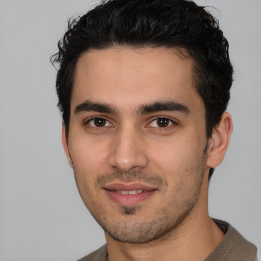 Joyful white young-adult male with short  black hair and brown eyes