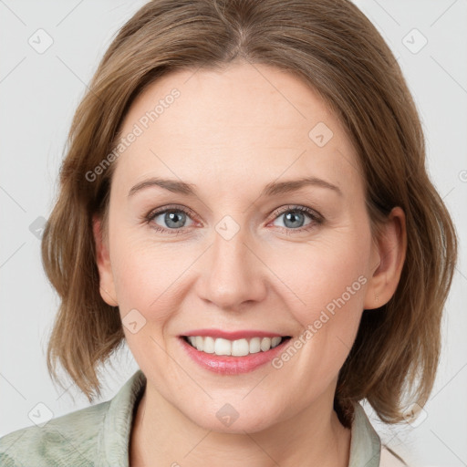 Joyful white young-adult female with medium  brown hair and blue eyes