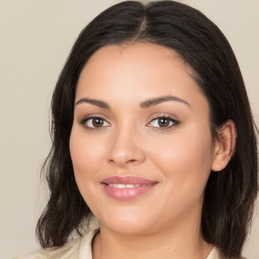 Joyful latino young-adult female with medium  brown hair and brown eyes