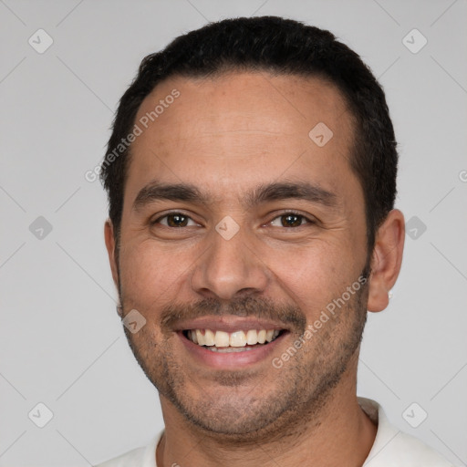 Joyful white young-adult male with short  black hair and brown eyes