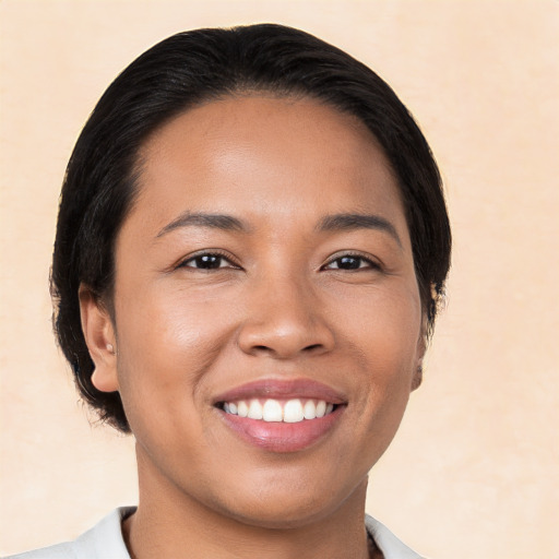 Joyful white young-adult female with medium  black hair and brown eyes