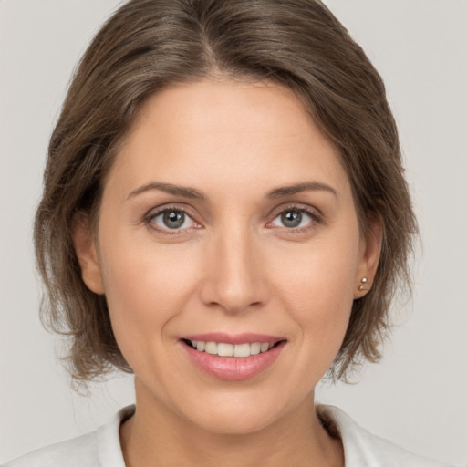 Joyful white young-adult female with medium  brown hair and brown eyes