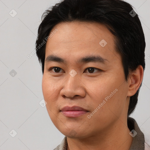 Joyful asian young-adult male with short  black hair and brown eyes