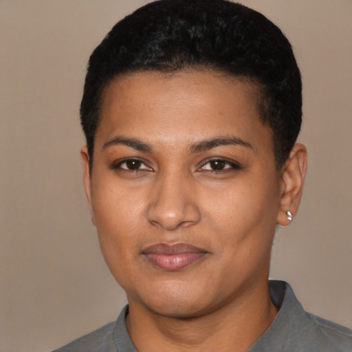 Joyful latino young-adult female with short  black hair and brown eyes