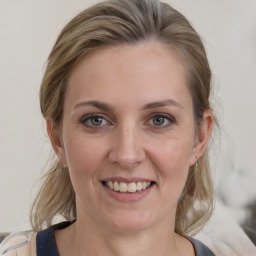 Joyful white adult female with medium  brown hair and grey eyes