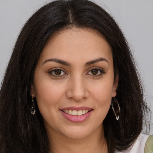 Joyful white young-adult female with long  brown hair and brown eyes