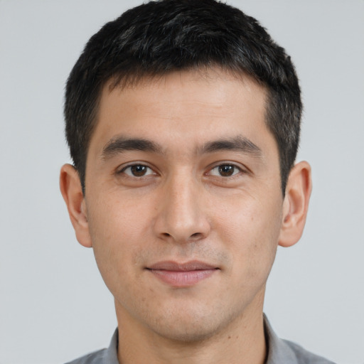 Joyful asian young-adult male with short  brown hair and brown eyes