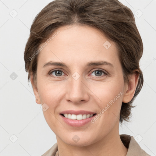 Joyful white young-adult female with medium  brown hair and grey eyes