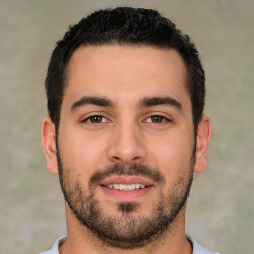 Joyful white young-adult male with short  black hair and brown eyes