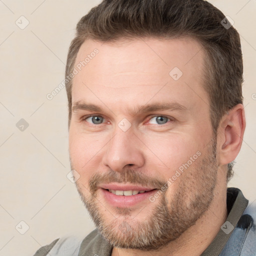 Joyful white adult male with short  brown hair and grey eyes