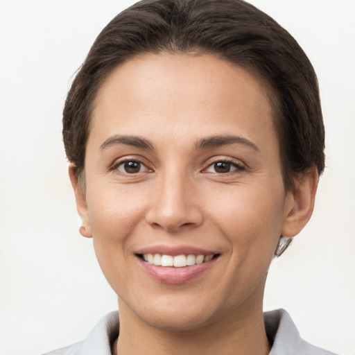 Joyful white young-adult female with short  brown hair and brown eyes