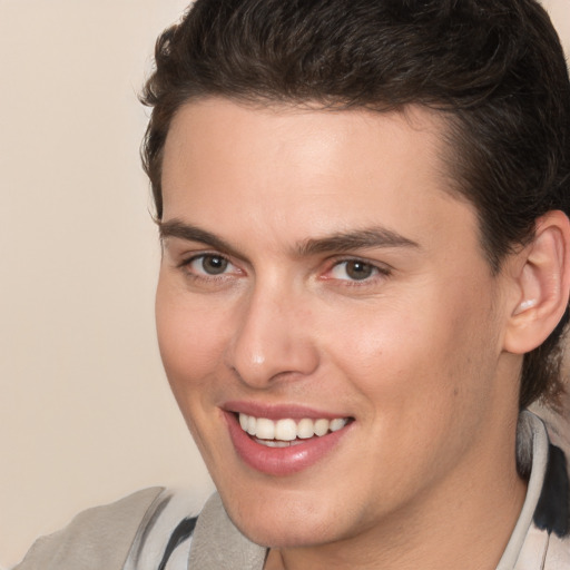 Joyful white young-adult male with medium  brown hair and brown eyes