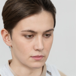 Neutral white young-adult female with short  brown hair and brown eyes