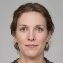 Joyful white adult female with medium  brown hair and grey eyes