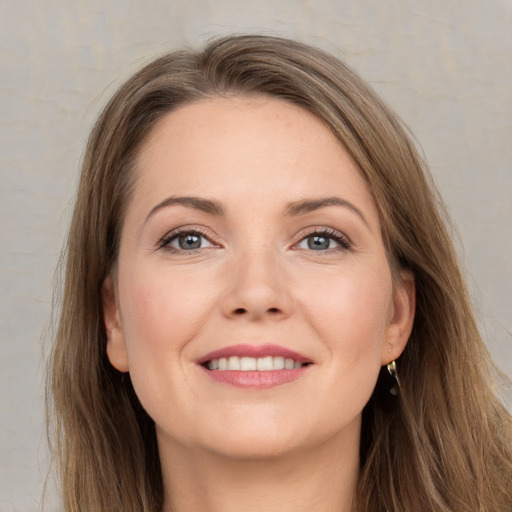 Joyful white young-adult female with long  brown hair and grey eyes