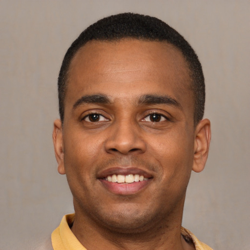 Joyful latino young-adult male with short  brown hair and brown eyes