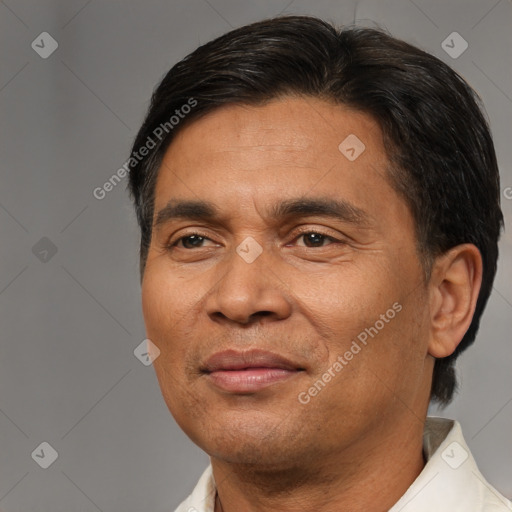 Joyful latino adult male with short  brown hair and brown eyes