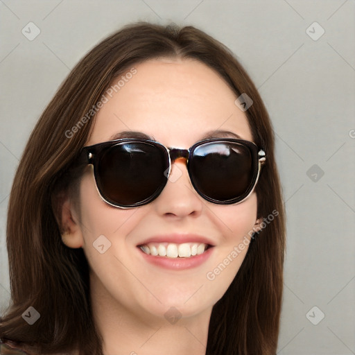 Joyful white young-adult female with long  brown hair and blue eyes