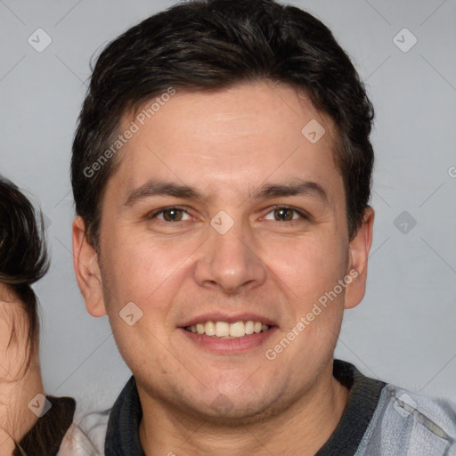 Joyful white adult male with short  brown hair and brown eyes