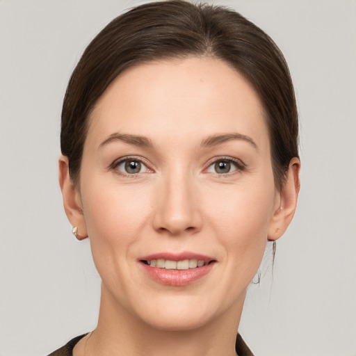 Joyful white young-adult female with short  brown hair and grey eyes