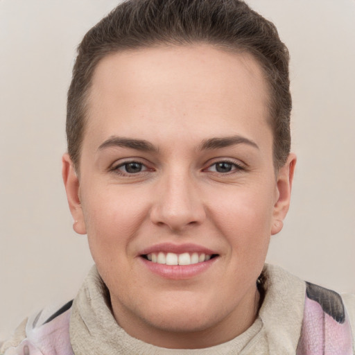 Joyful white young-adult female with short  brown hair and grey eyes