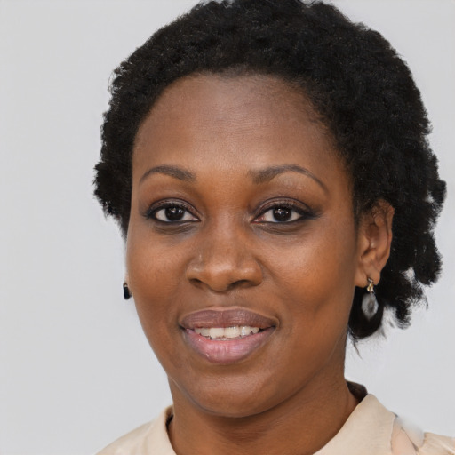Joyful black adult female with short  black hair and brown eyes