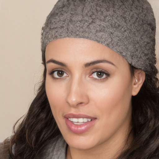 Joyful white young-adult female with long  black hair and brown eyes